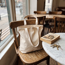 The tote resting on a cafe chair